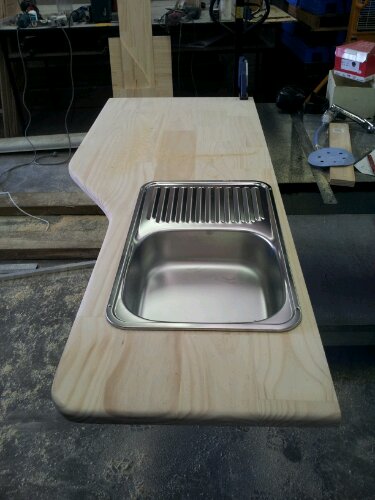 beautifully shaped kitchen bench top with (resting) sink